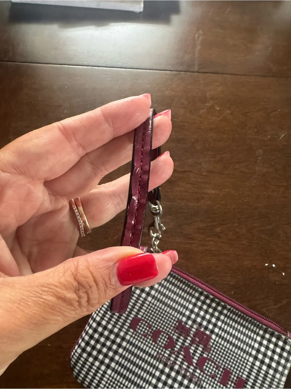 Coach Black-and-White Gingham Wristlet with Pink Logo